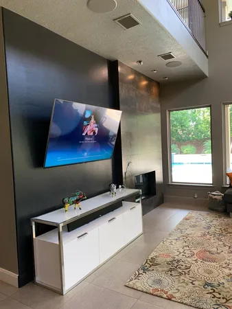 a living room with furniture rug and a flat screen tv