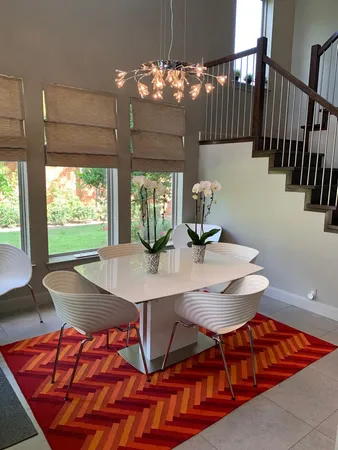 a view of a dining room with furniture and a chandelier