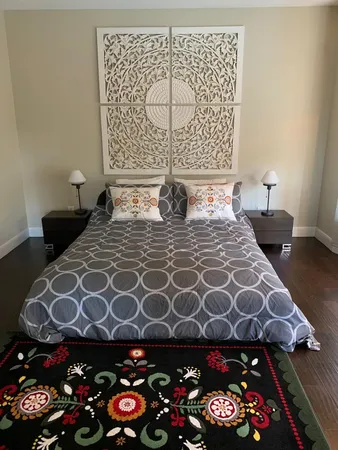 a bedroom with a bed and a lamp on the table