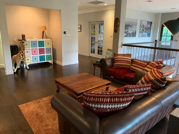 a living room with furniture and a floor to ceiling window