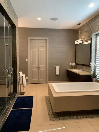 a hallway with a couch and a potted plant on the dresser