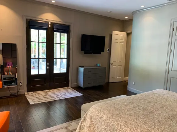 a bedroom with a bed and flat screen tv