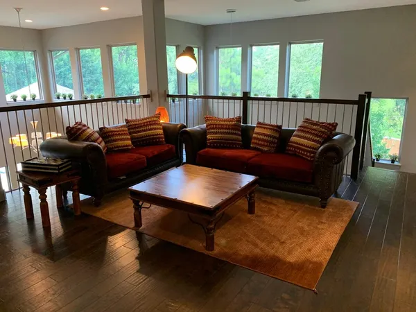 a living room with furniture and wooden floor