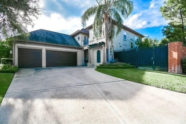 a front view of house with yard and trees
