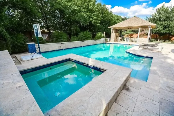 swimming pool view with a garden space