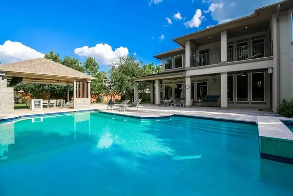 a view of an house with swimming pool and porch