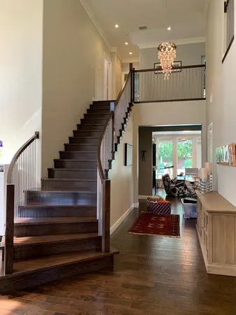 a living room with furniture wooden floor and a chandelier