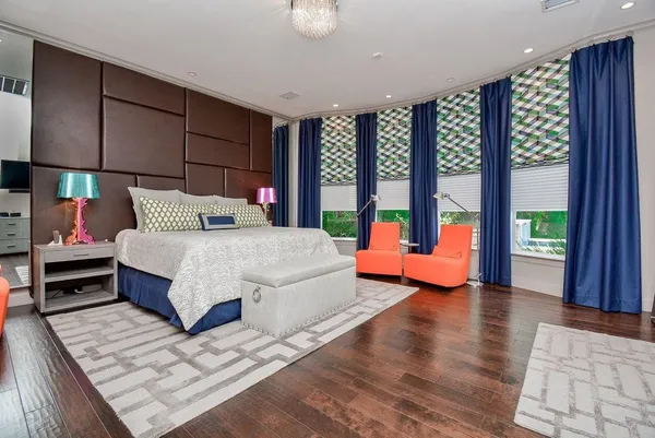 a bedroom with a bed and large window