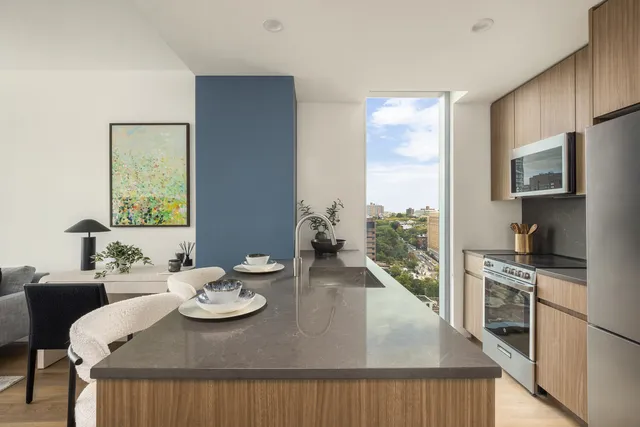 a view of a dining room with furniture a kitchen kitchen and wooden floor
