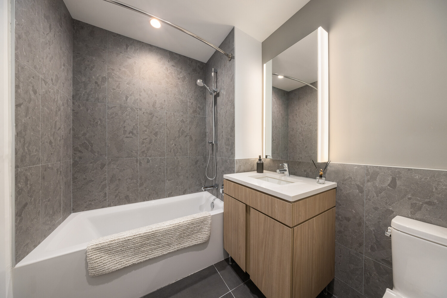 89 DeKalb Avenue, Unit 5A Brooklyn, NY 11201 - Photo 7 of 17 a bathroom with a sink a toilet and bathtub