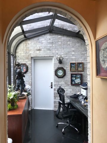 a dining room with furniture and floor to ceiling window