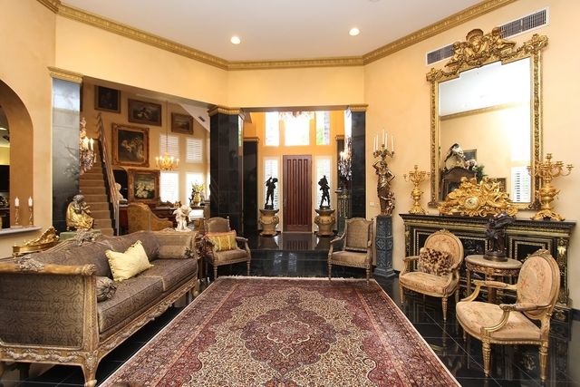 a living room with fireplace furniture and a large window