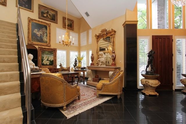 a living room with fireplace furniture and a large window