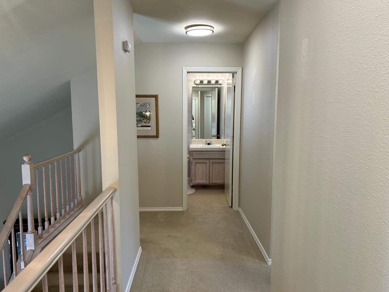 1067 Rio Cidade Way Sacramento, CA 95831 - Photo 17 of 33 a view of a hallway with bathroom and a sink
