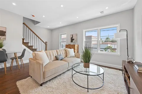 a living room with furniture potted plant and a window