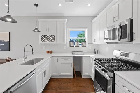 a kitchen that has a sink and a stove