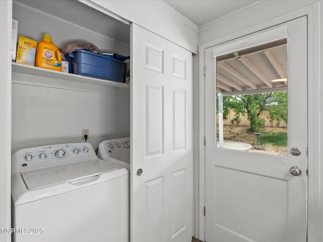 front view of a house with table and chairs in patio