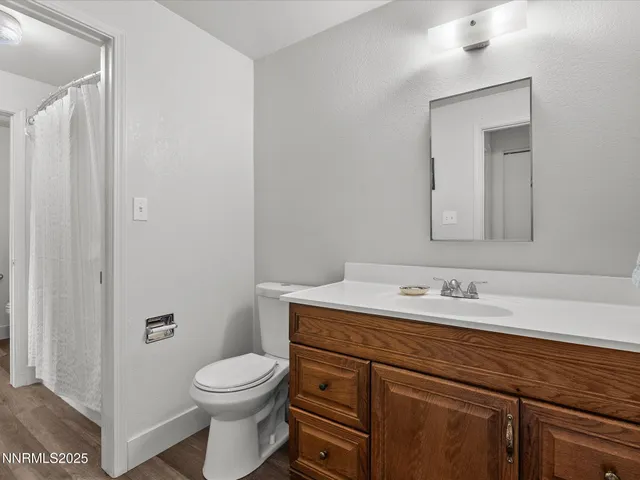 an aerial view of a house with table & chairs and a garden