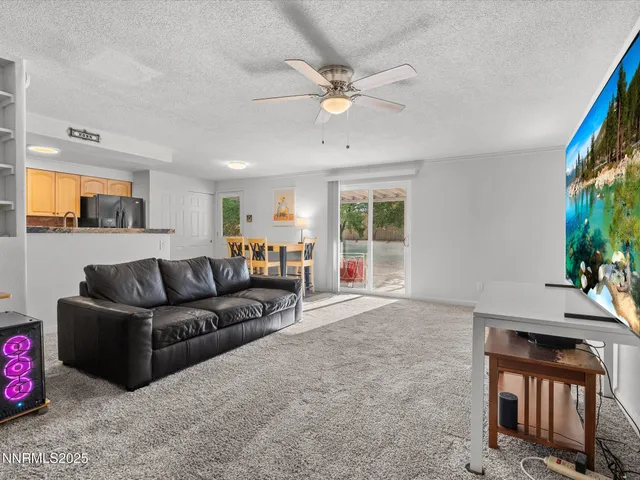 a kitchen with stainless steel appliances granite countertop a refrigerator a sink and a stove