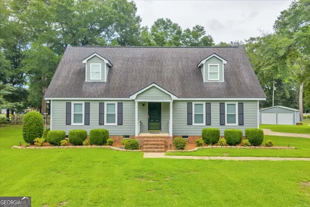 a front view of a house with a garden