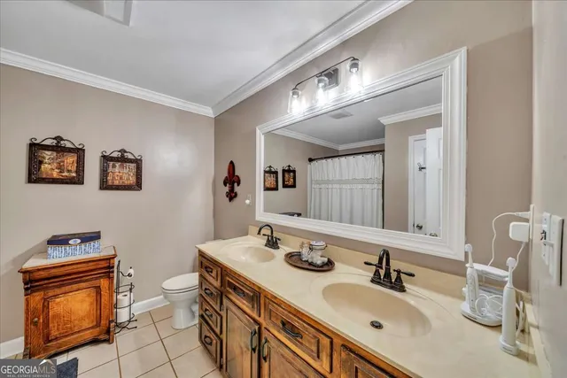 a bathroom with a sink double vanity granite and a mirror