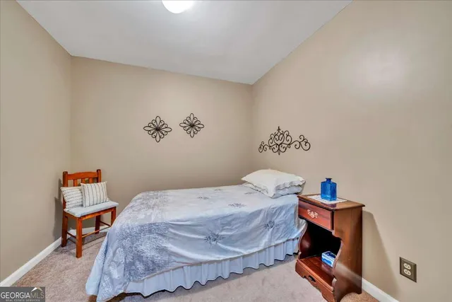 a bedroom with a bed and a table in it