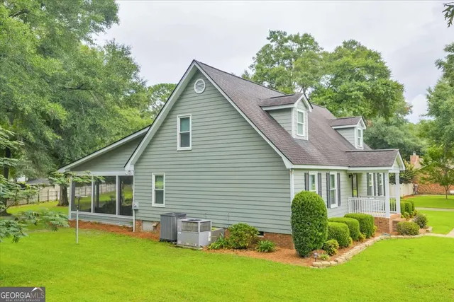 a view of a house with a yard and a garden