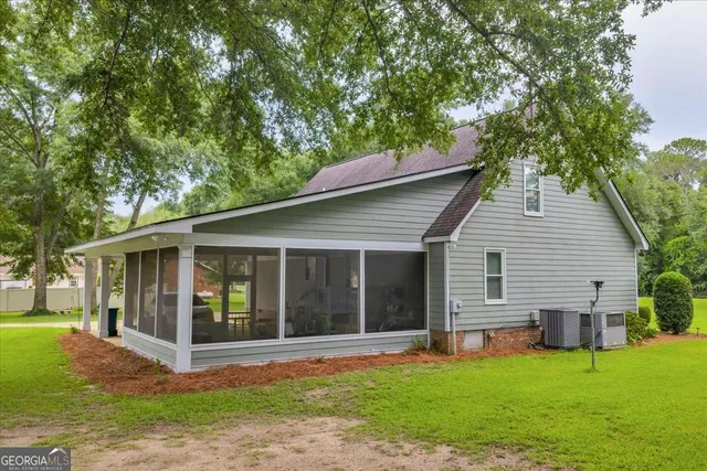 a view of a house with a yard and plants
