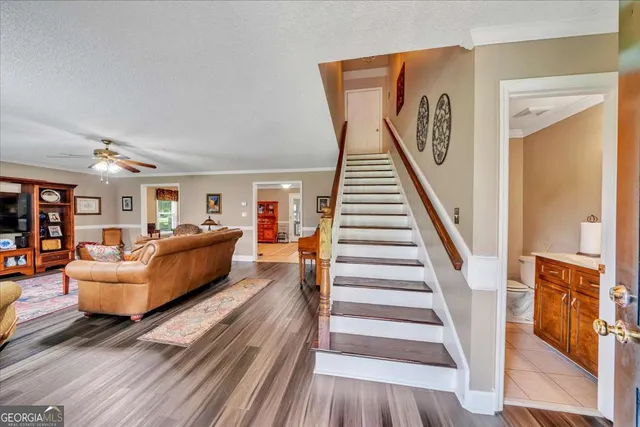a living room with furniture and a wooden floor