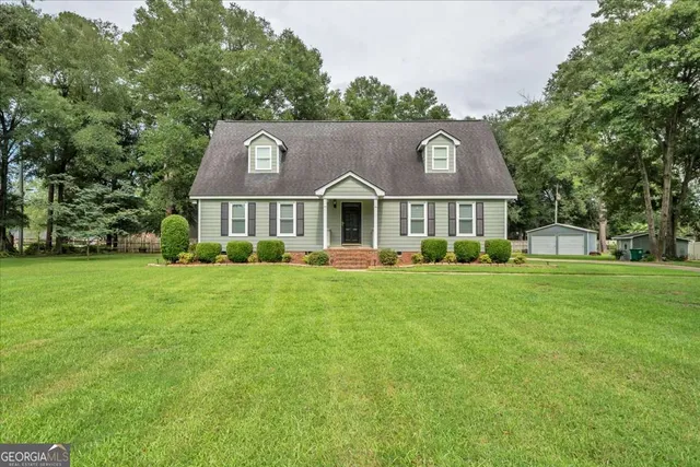 a front view of house with yard and green space