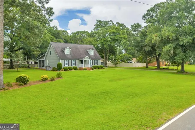 a view of yard with swimming pool and green space