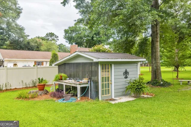 a view of a house with a yard balcony and chairs