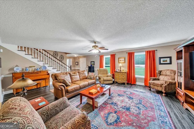 a living room with furniture a rug and a chandelier