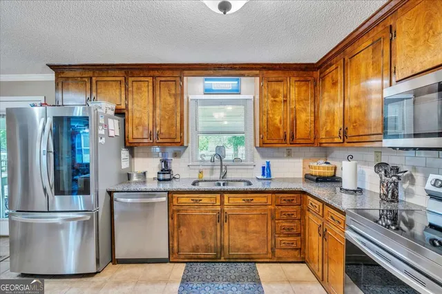 a kitchen with stainless steel appliances granite countertop a refrigerator sink and cabinets
