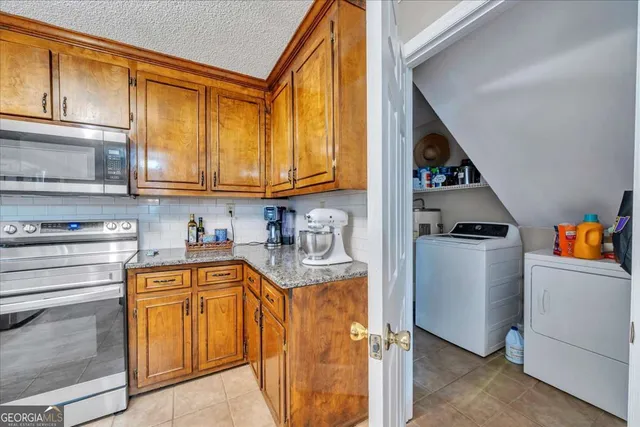 a kitchen with stainless steel appliances granite countertop a stove and a refrigerator