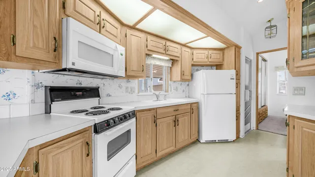 a kitchen with appliances a sink and a cabinets