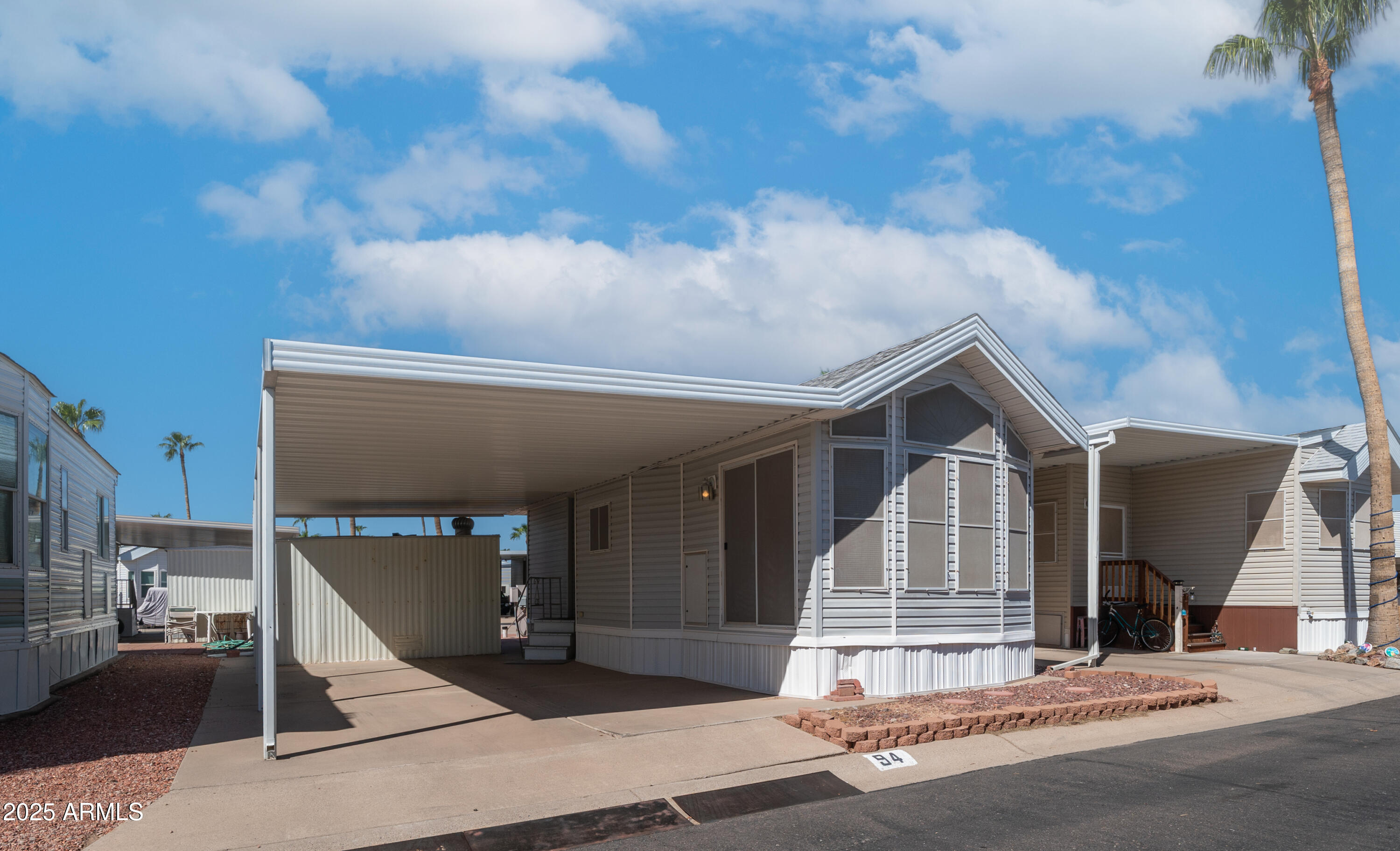 3710 South Goldfield Road, Unit 94 Apache Junction, AZ 85119 - Photo 13 of 48 a view of a house with a patio