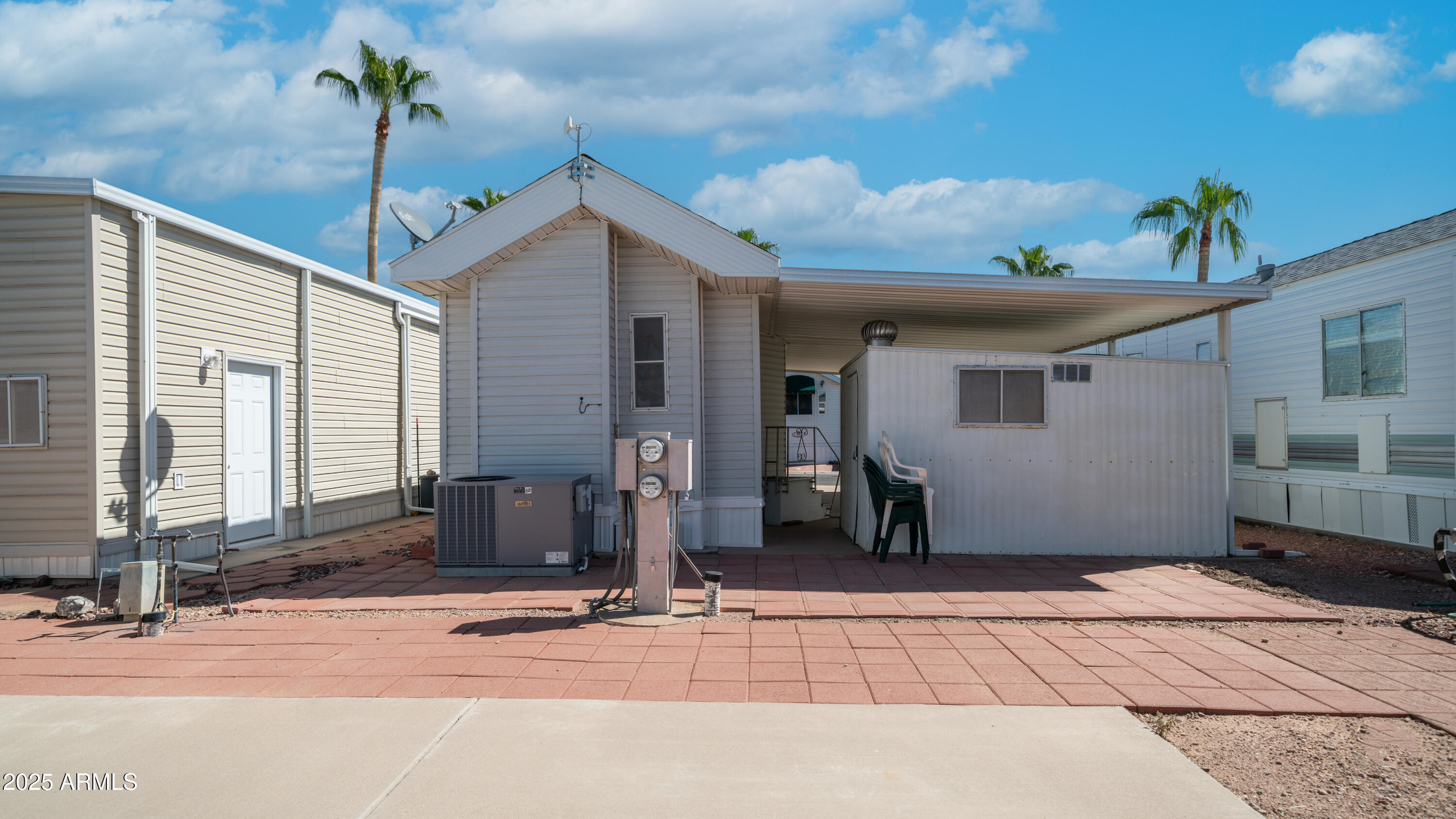 3710 South Goldfield Road, Unit 94 Apache Junction, AZ 85119 - Photo 18 of 48 a front view of a house with garden
