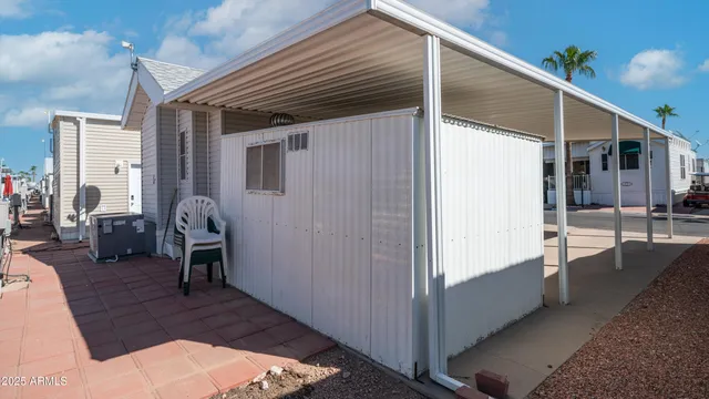 a view of a house with a yard table and chairs