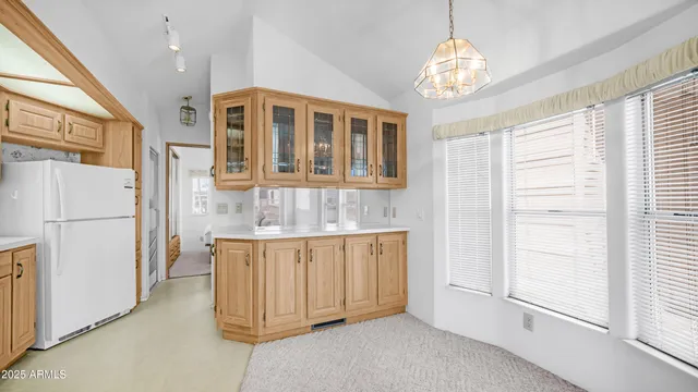 a view of a kitchen with an entryway and chandelier