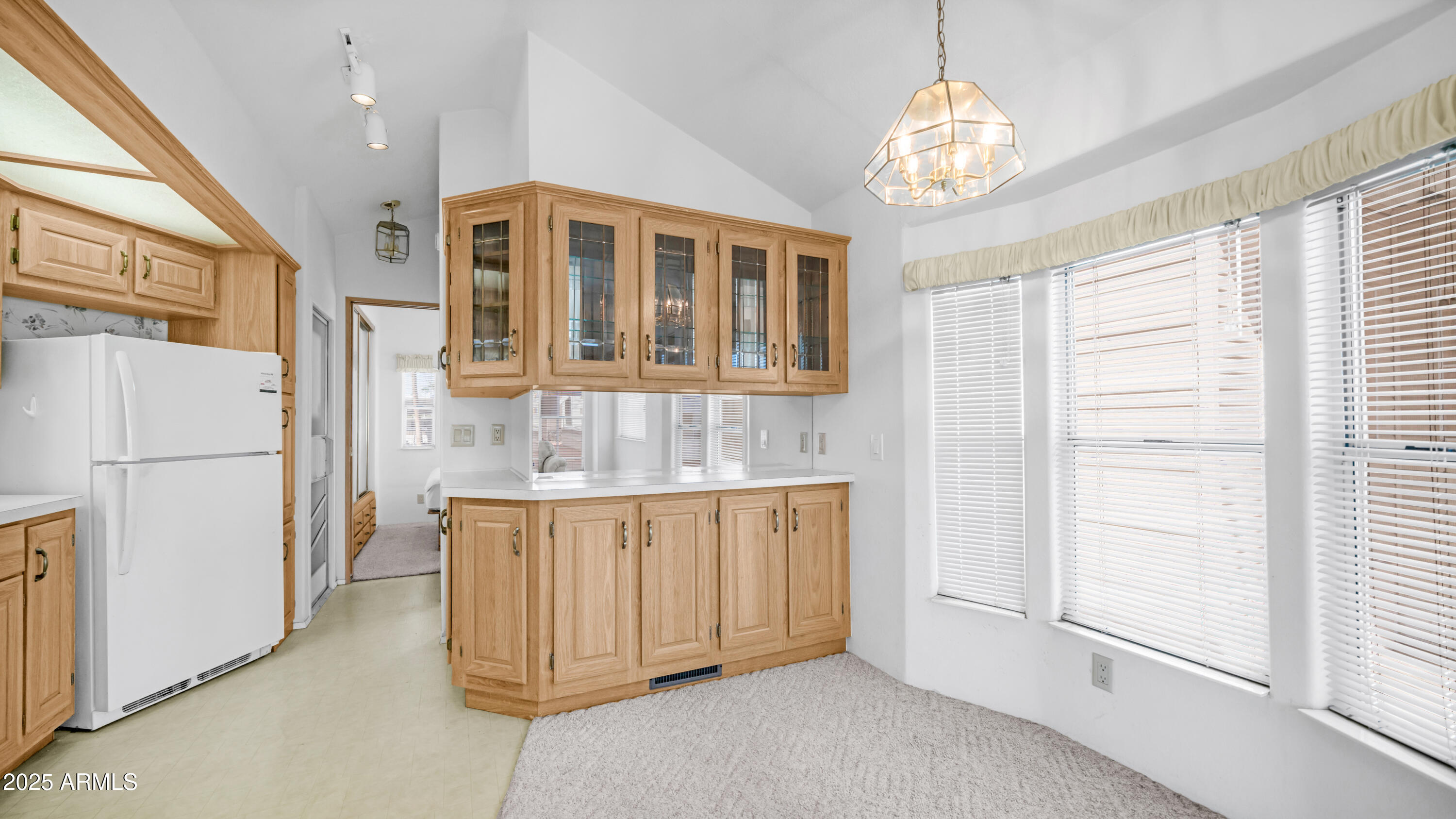 3710 South Goldfield Road, Unit 94 Apache Junction, AZ 85119 - Photo 5 of 48 a view of a kitchen with an entryway and chandelier