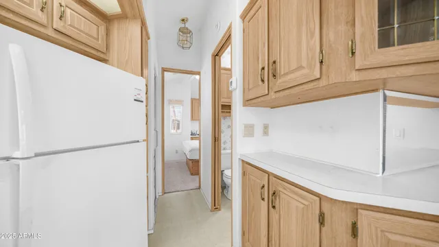 a view of cabinets and white refrigerator