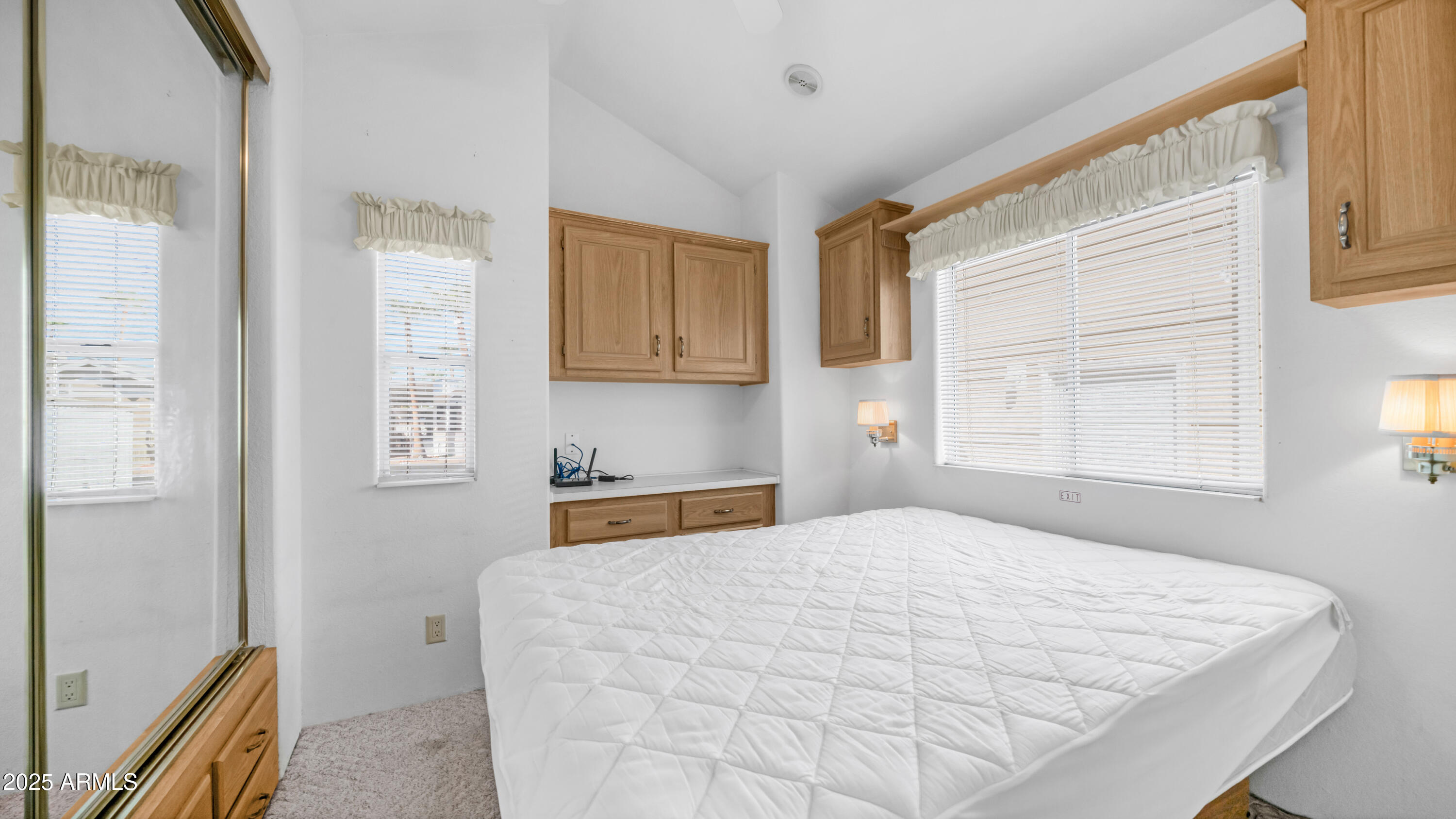 3710 South Goldfield Road, Unit 94 Apache Junction, AZ 85119 - Photo 9 of 48 a bedroom with a bed and a window