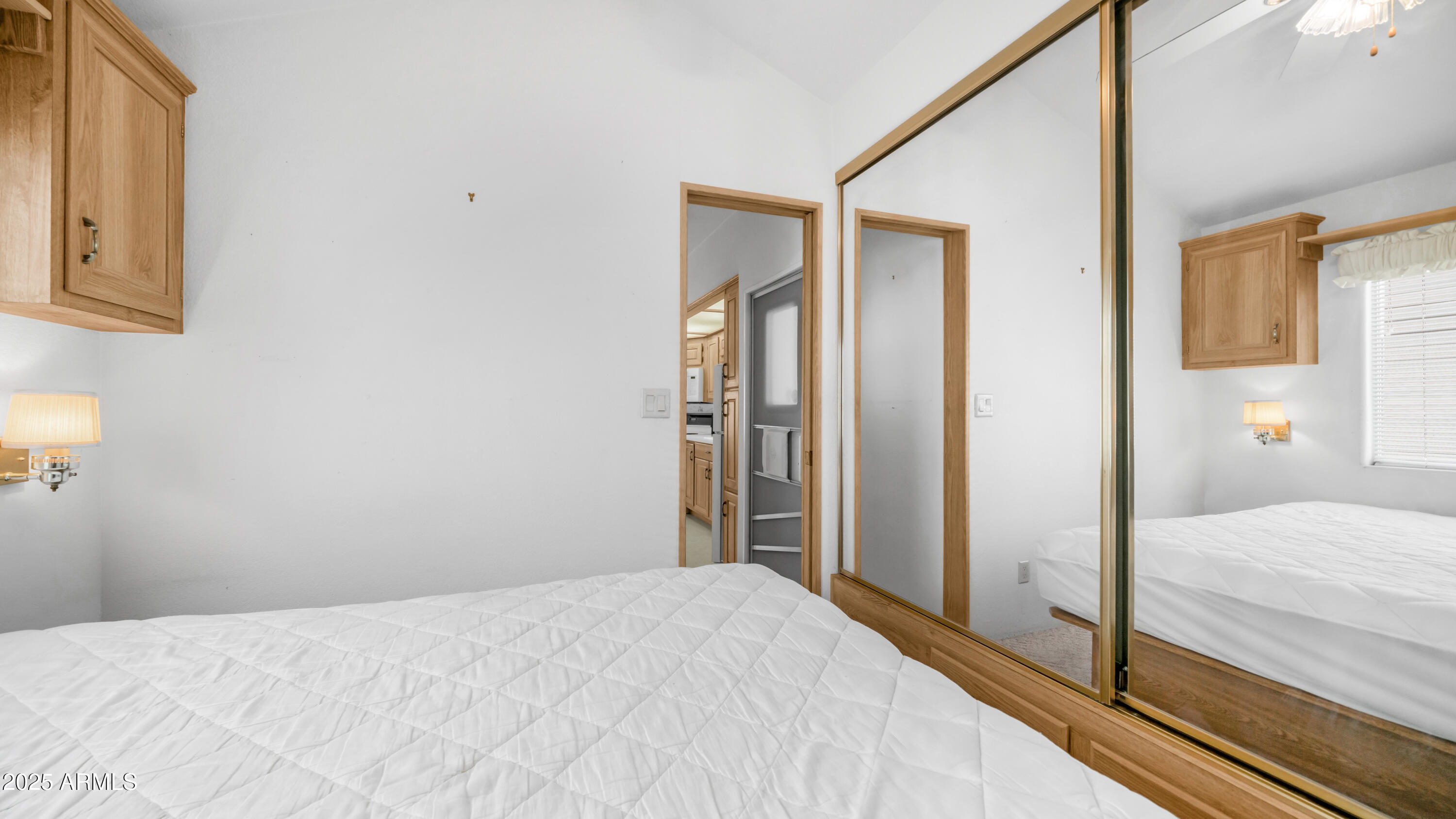 3710 South Goldfield Road, Unit 94 Apache Junction, AZ 85119 - Photo 10 of 48 a bedroom with a bed and a mirror