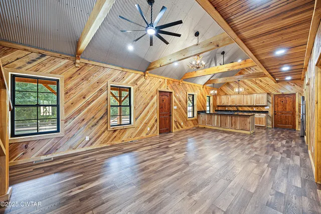 a view of a room with wooden floor