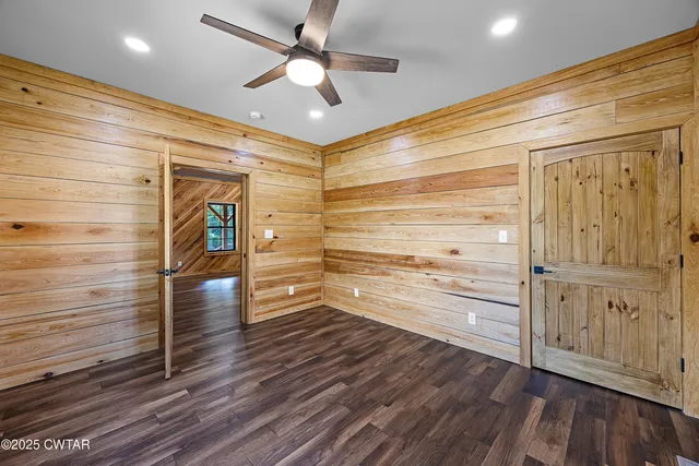 a view of walk in closet with wooden floor