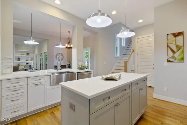 a kitchen that has a sink a stove and window
