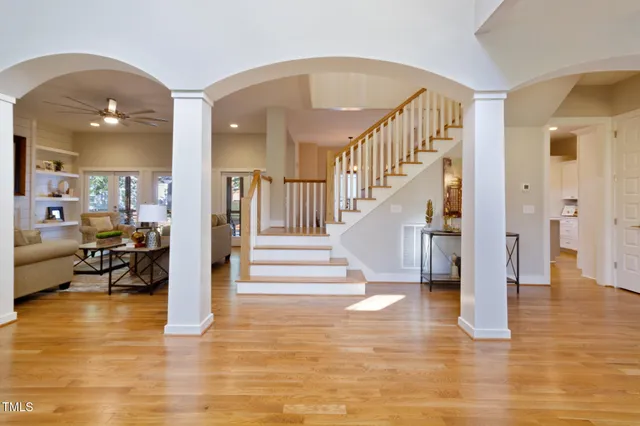 a large white kitchen with cabinets a sink and dishwasher