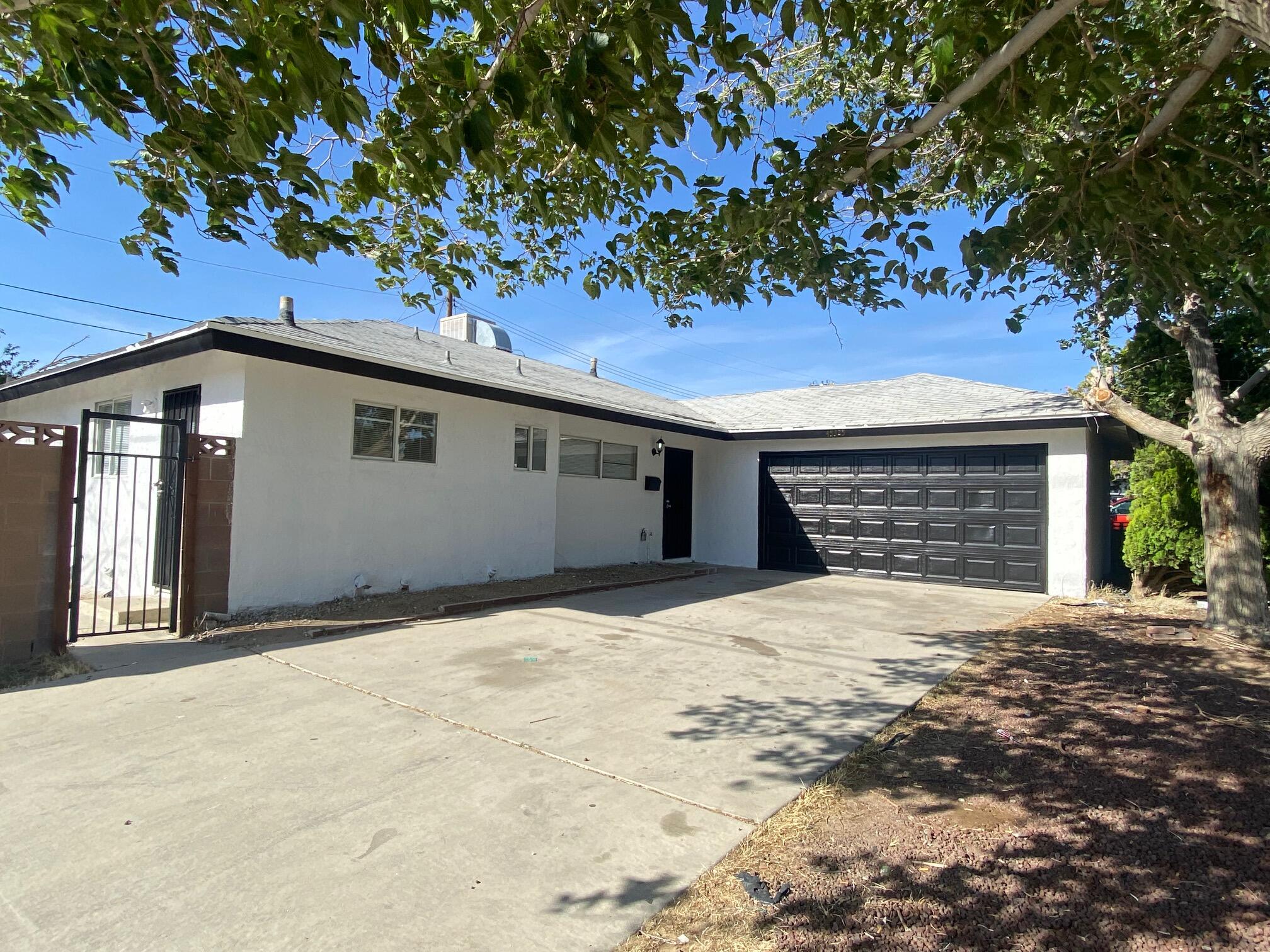 45325 Raysack Avenue Lancaster, CA 93535 - Photo 1 of 17 a front view of a house with a tree