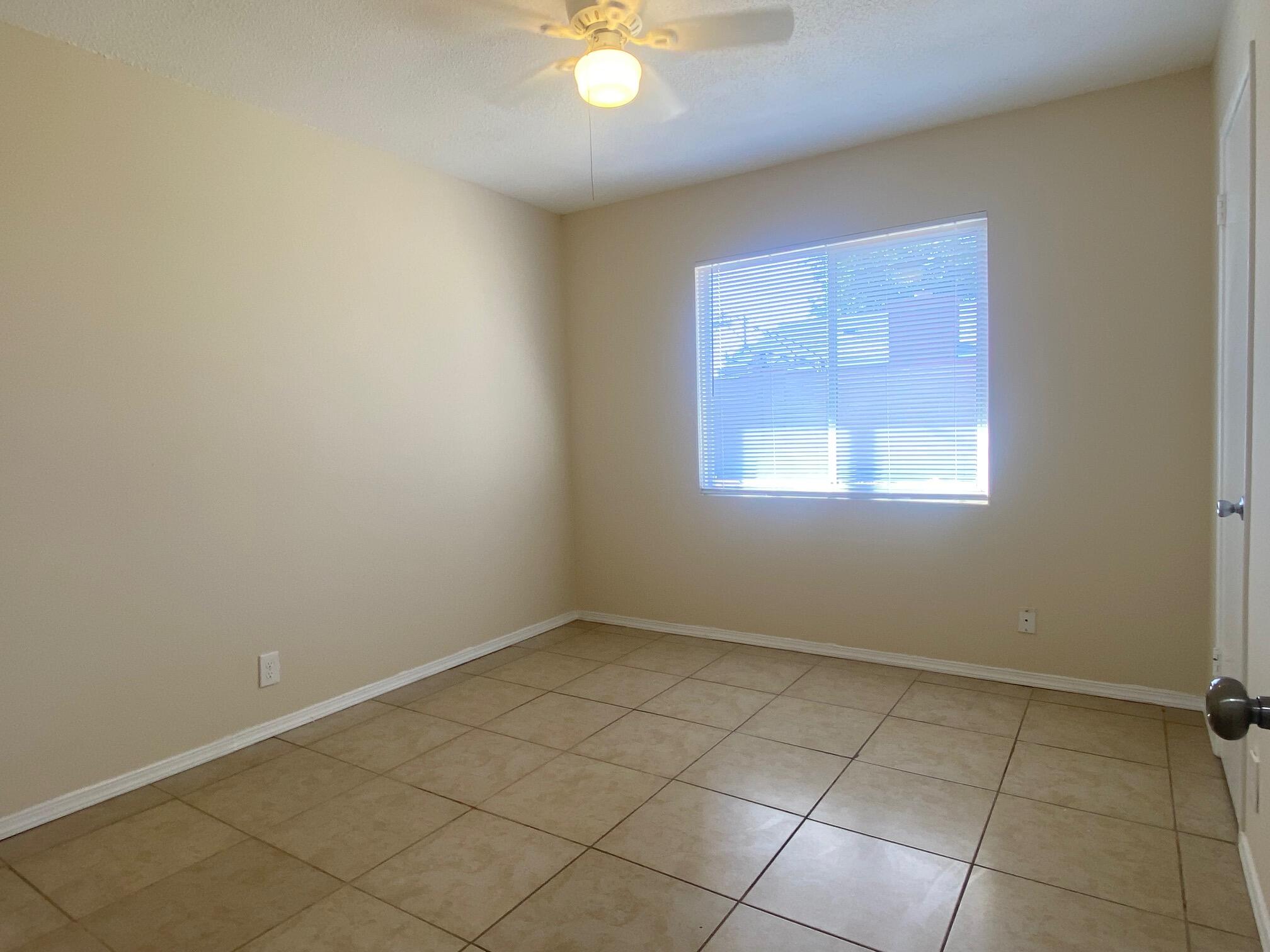 45325 Raysack Avenue Lancaster, CA 93535 - Photo 12 of 17 an empty room with windows and fan